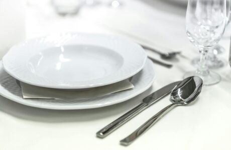 round white ceramic bowl placed on table beside wine glass