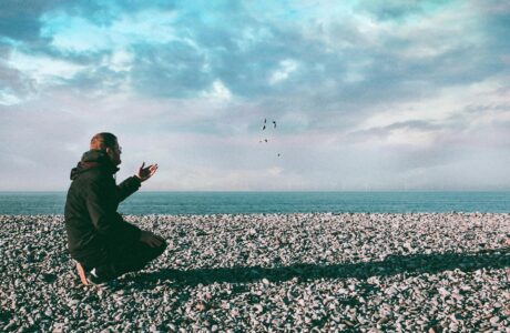 man throwing stones