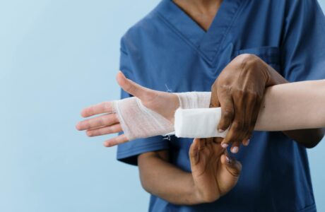 a person getting his hand bandaged